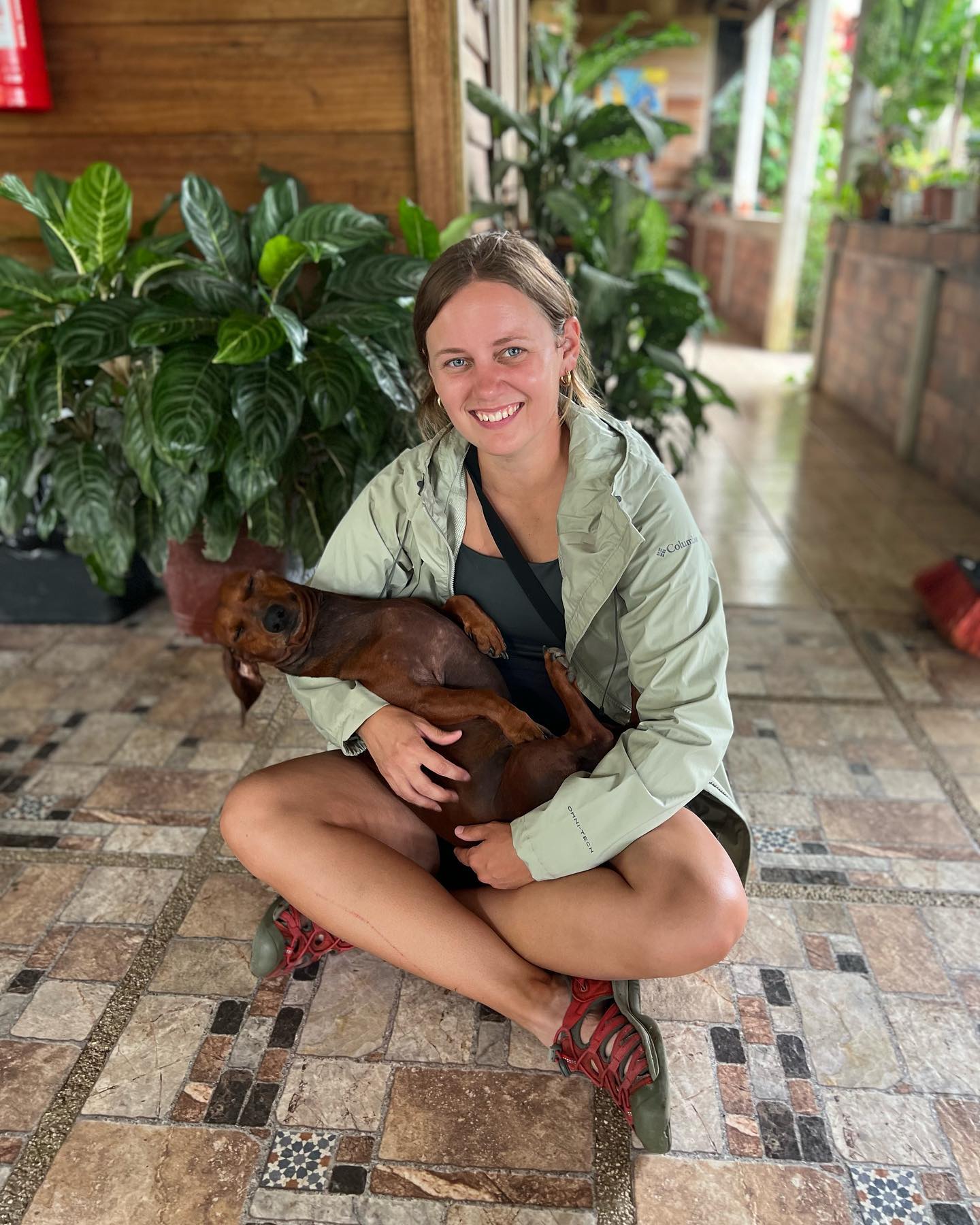 Elise holding a dog.